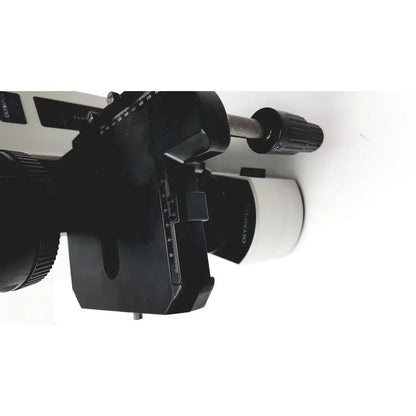 Black and white olympus bx51tf microscope with adjustable focus knobs and measurement scales showing minor body damage