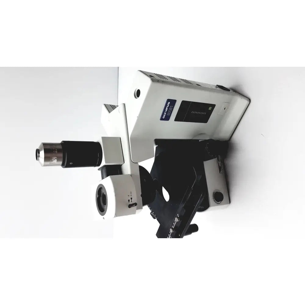 White and black olympus bx51tf microscope with metallic objective lenses showing some damage on body in working condition
