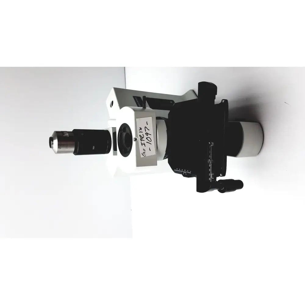 Black and white olympus bx51tf microscope showing labeled specimen stage with minor damage on body in working condition