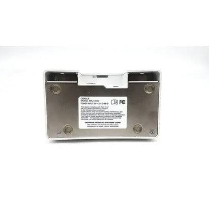 Silver metallic olympus capsule recorder re-10 medical device with white label and maj-2032 cradle backside view