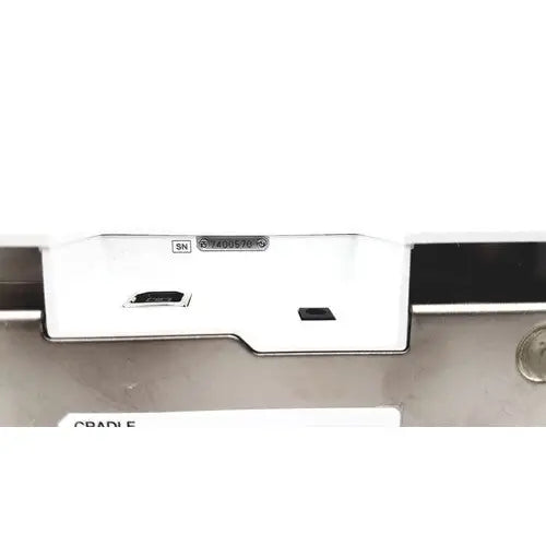 White plastic rectangular Olympus capsule recorder RE-10 with two black ports and MAJ-2032 cradle shown from back side