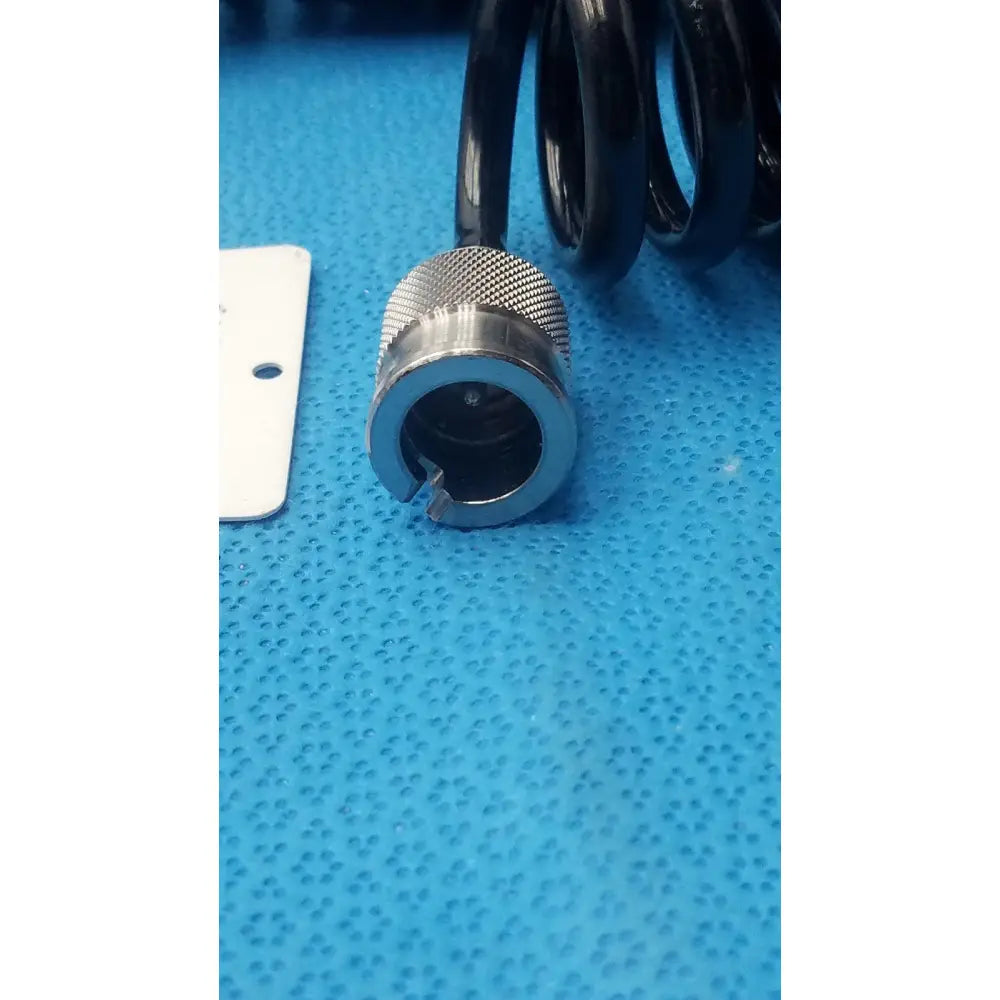 Black coiled cable with metallic textured connector for Olympus endoscope leakage tester device accessory