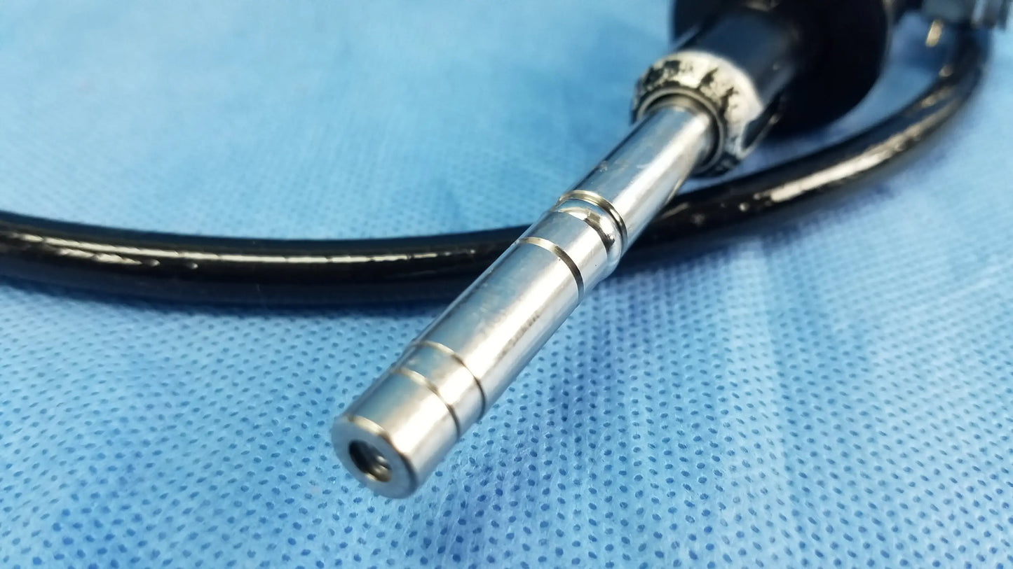 Silver metallic end of an olympus flexible fiber optic endoscope rhino-laryngoscope with black tubing visible