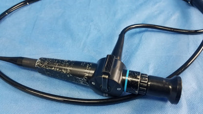Black Olympus ENF-P4 rhino-laryngoscope flexible fiber optic endoscope with textured grip and blue accent ring near lens