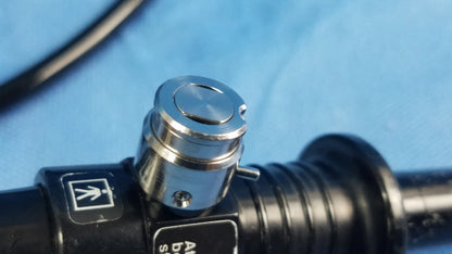 Silver metallic control knob with ridged sides on black cylindrical flexible fiber optic endoscope device olympus enf-p4