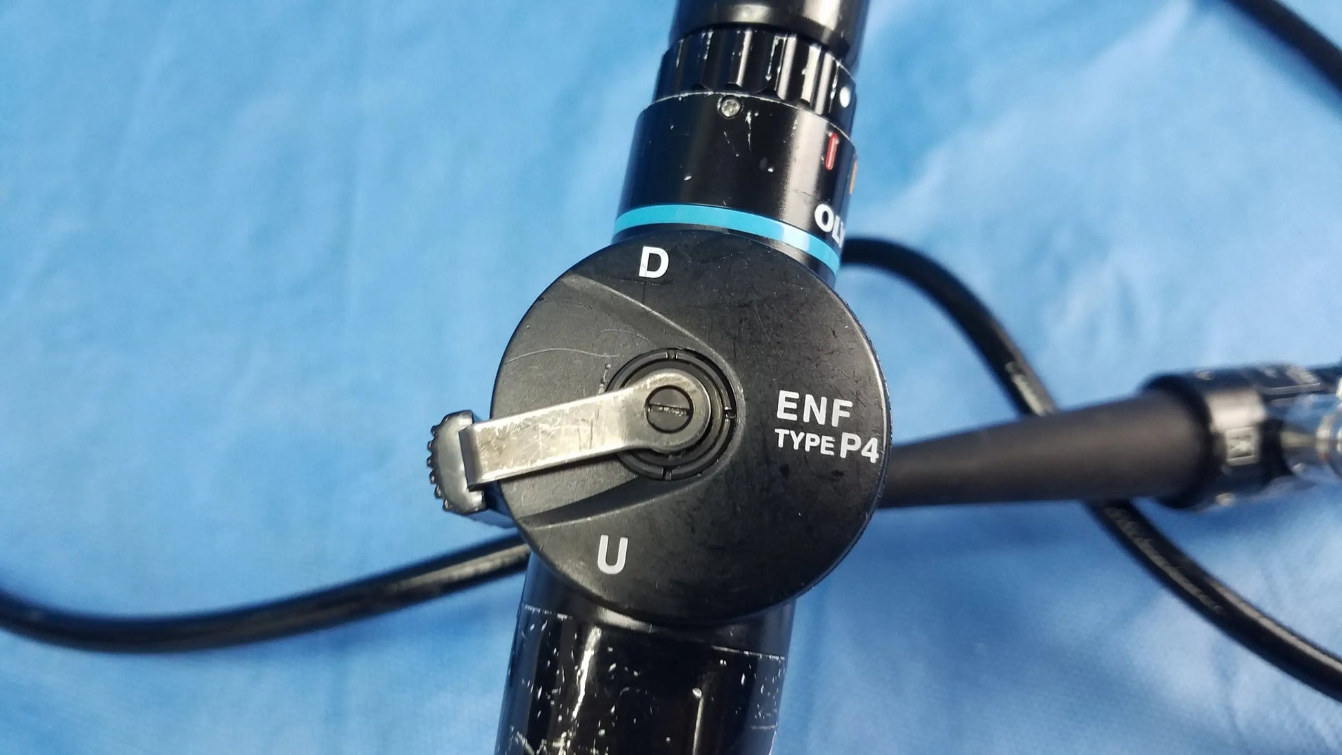Black olympus rhino-laryngoscope type enf-p4 flexible fiber optic endoscope with metallic knob and blue accent ring