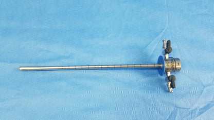 Silver metallic shaft surgical instrument component with blue circular handle and black knobs for cysto-urethroscope systems
