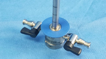 Silver surgical instrument component with black handles and blue base featuring engraved markings for cysto-urethroscope systems
