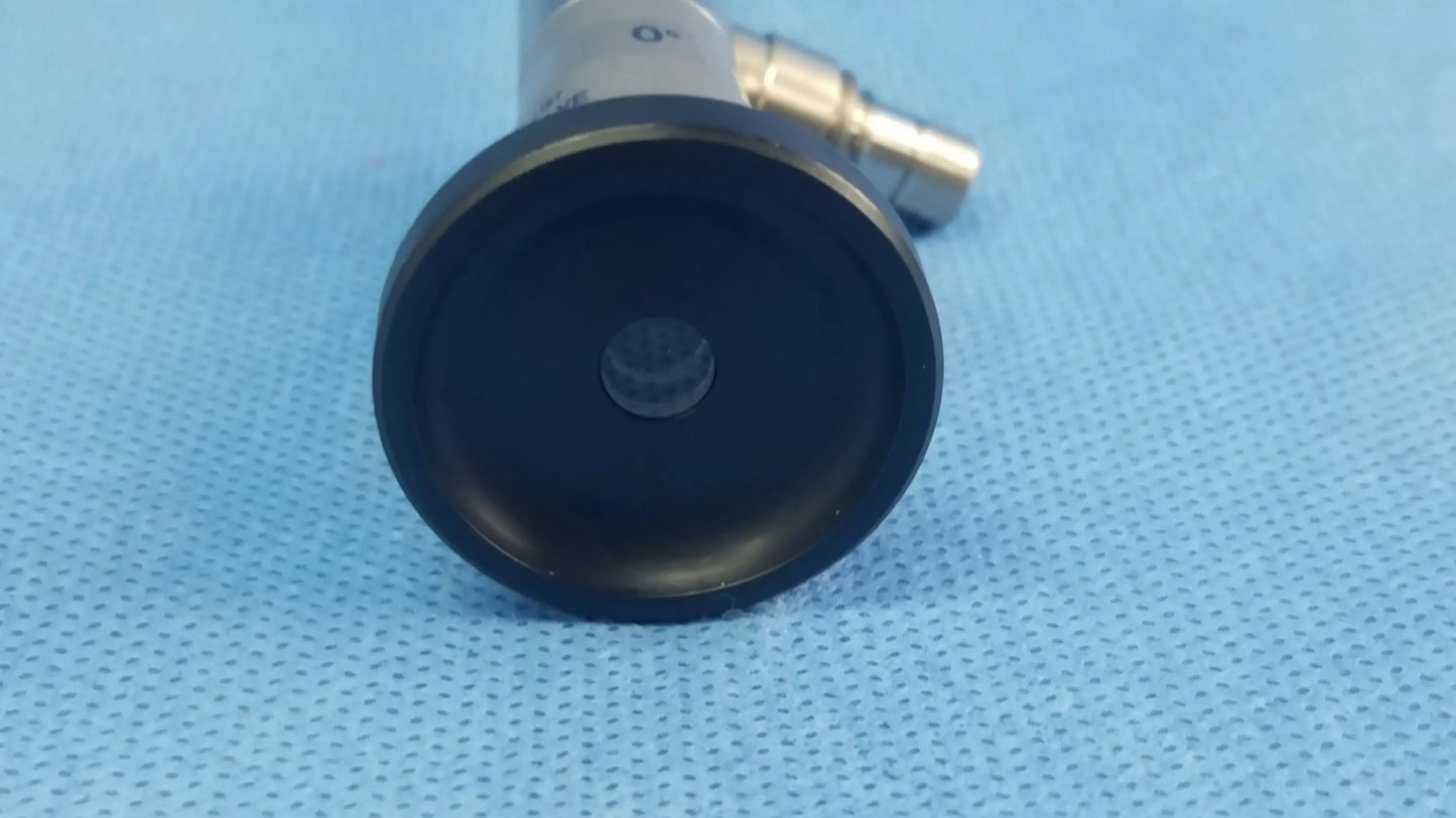 Black circular end cap with central lens attached to metallic body of compatible olympus cystoscopic a22000a autoclave cystoscope