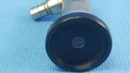 Black rubberized end cap with circular indentation attached to metallic body of olympus germany a22002a compatible olympus cystoscopic system