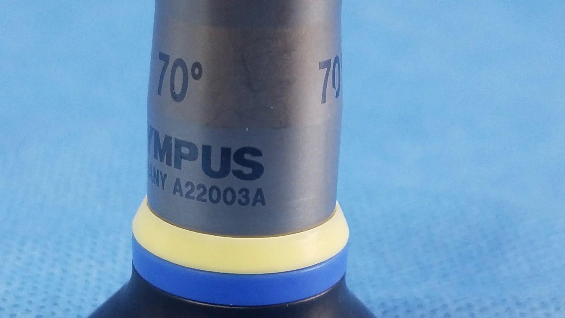 Silver olympus endoscopic rigid telescope a22003a with yellow and blue ring marked 70 degrees for medical use