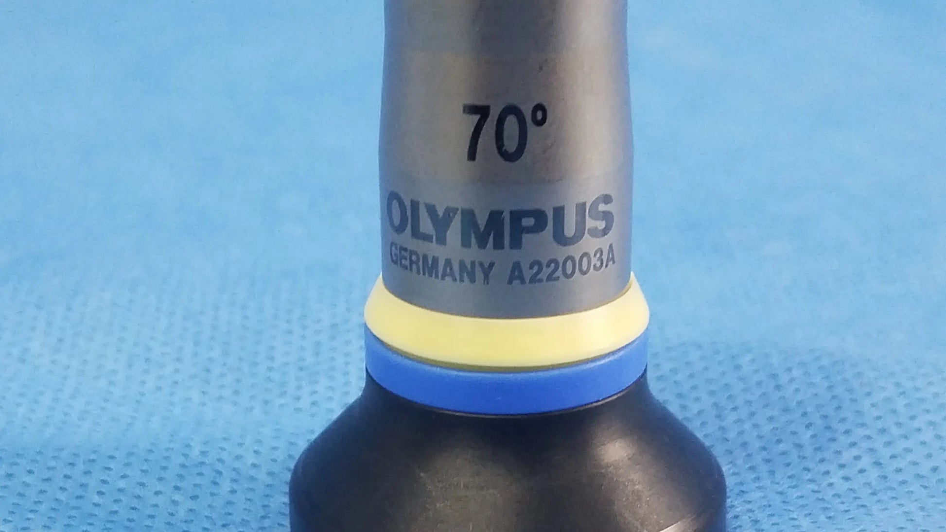 Silver-colored olympus a22003a rigid telescope lens with 70° angle marking and yellow blue rubber rings for olympus endoscopic use