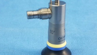 Silver metallic olympus endoscopic a22003a rigid telescope with black rubber base and yellow-blue ring on cylindrical body