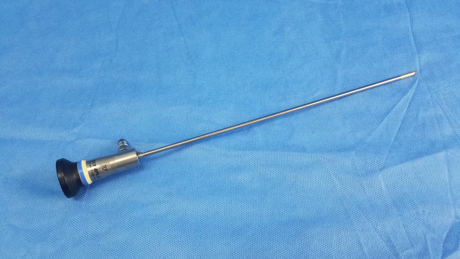 Silver rigid telescope with black tip and blue yellow labeling on handle of olympus endoscopic a22003a model