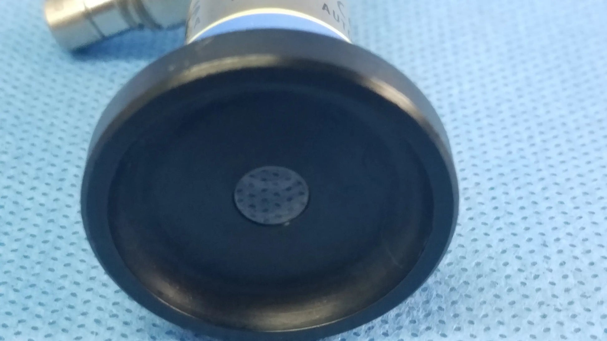 Black rubberized base with central perforated disc attached to metallic cylinder of olympus germany a22003a rigid telescope compatible with olympus endoscopic systems