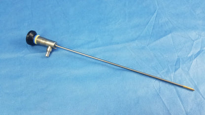 Medical-grade stainless steel rigid telescope with black rubberized handle and yellow accent ring for compatible Olympus endoscopic systems