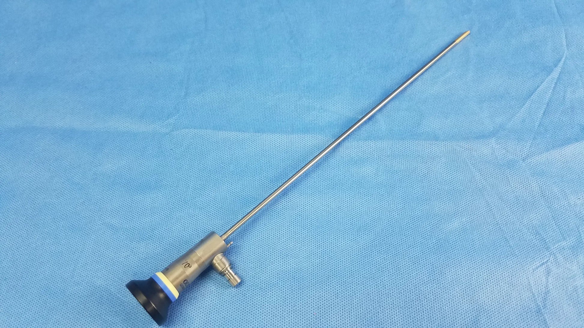 A metallic rigid telescope with a slender shaft and black blue silver handle compatible with Olympus endoscopic systems