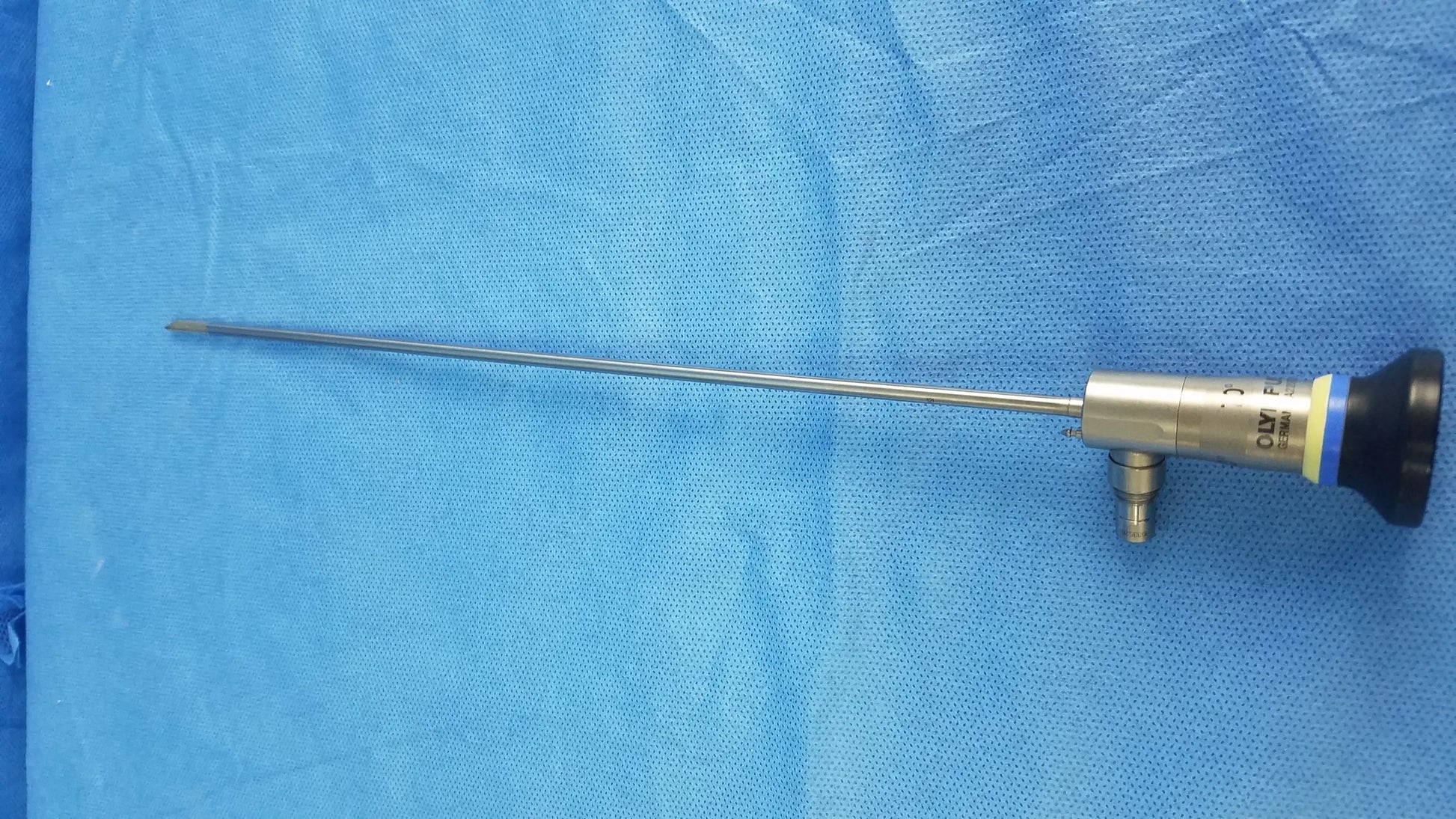 Silver surgical rigid telescope with black and yellow handle and metallic shaft compatible with Olympus endoscopic systems