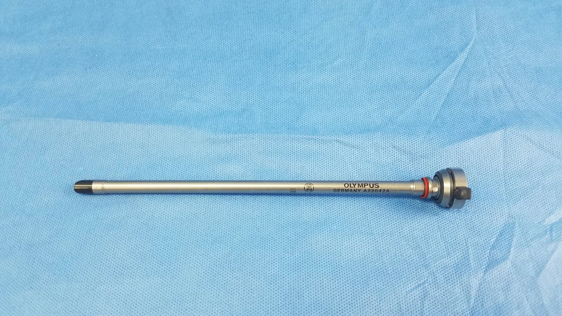Silver-colored olympus germany a22042a 26fr resection sheath with textured grip and engraved branding instrument component