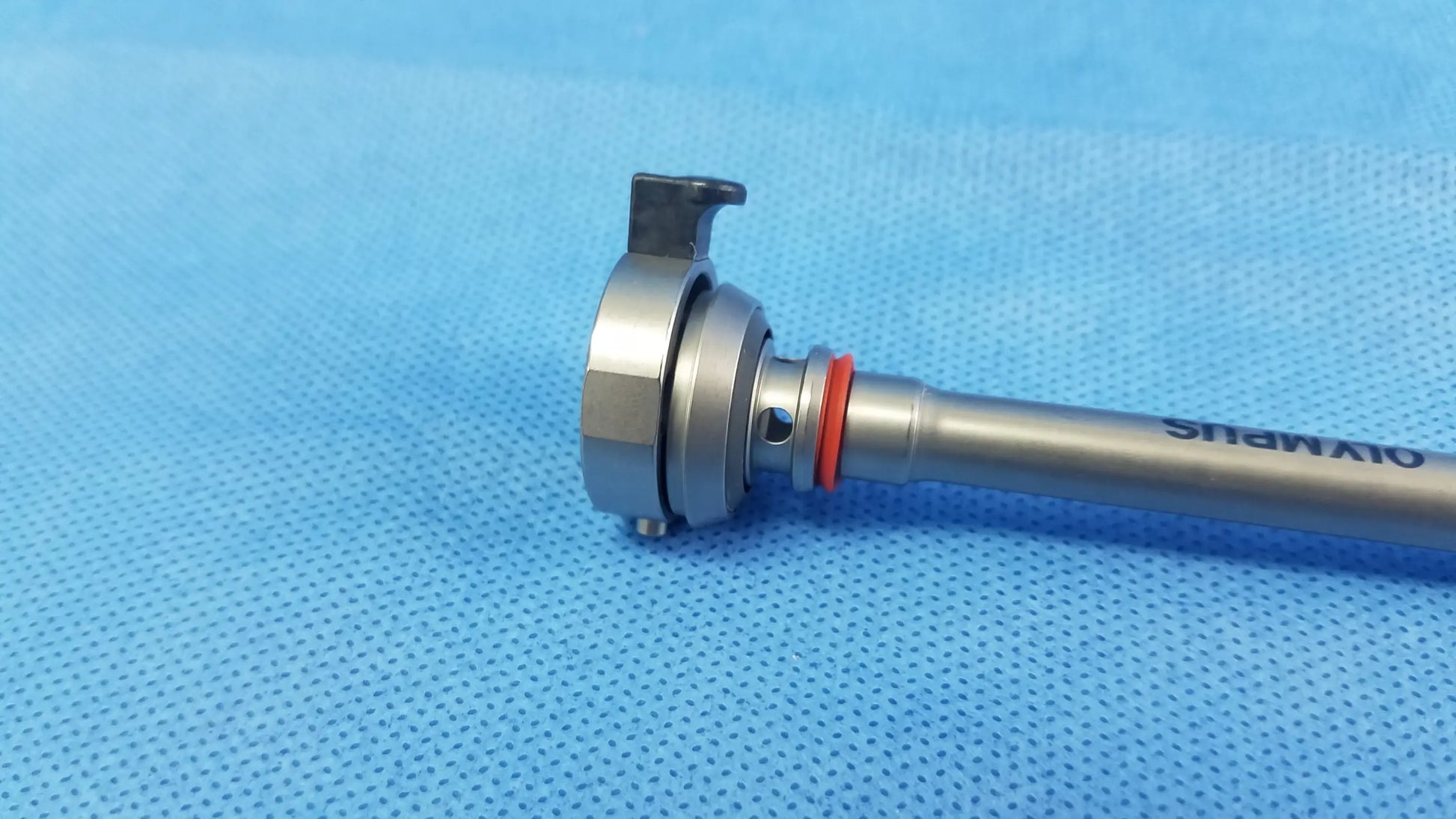 Silver-colored olympus germany a22042a 26fr resection sheath with metallic shaft and orange o-ring instrument component
