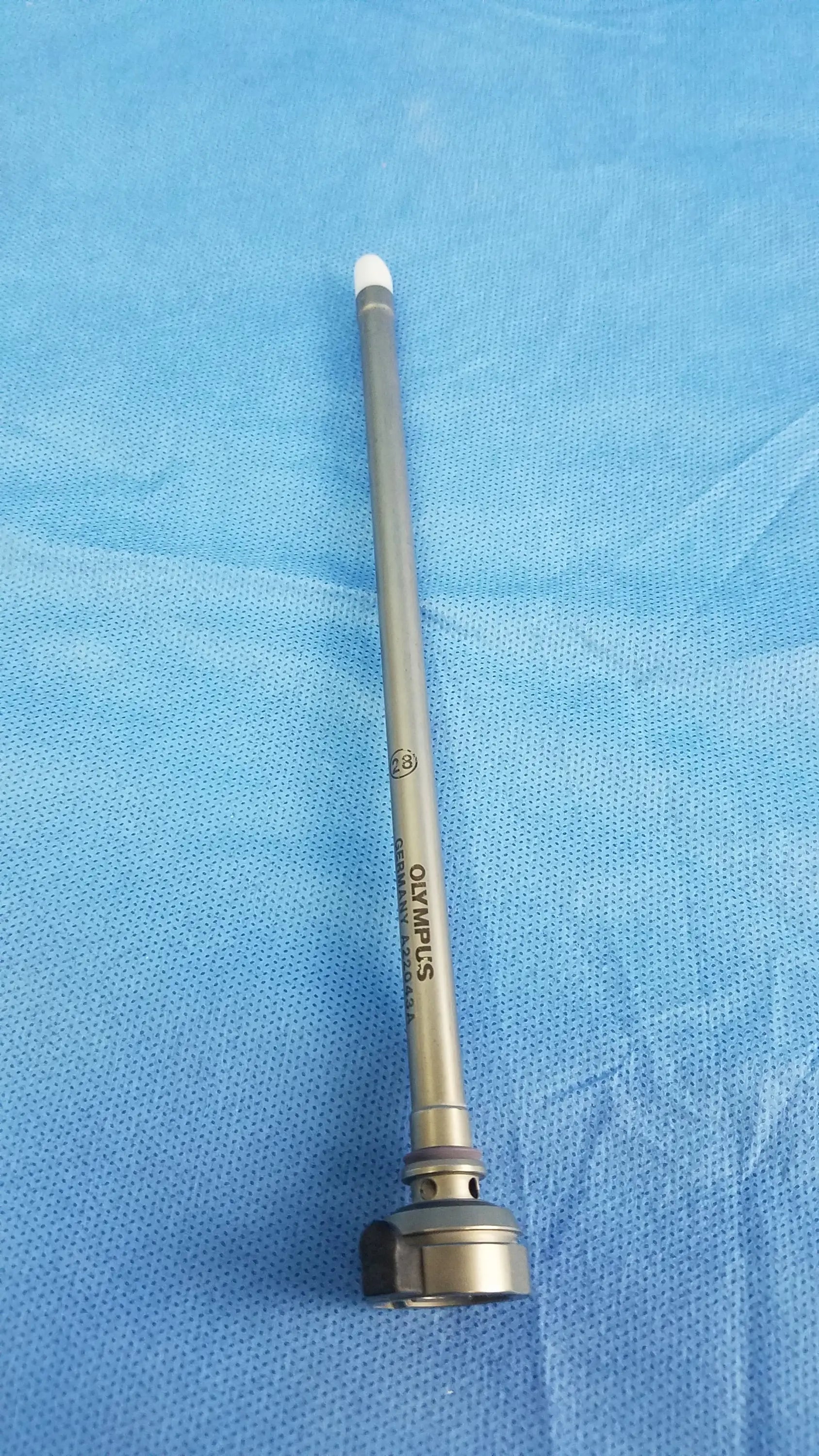 Silver-colored metal 28fr resection sheath with white tip and engraved Olympus Germany branding instrument component