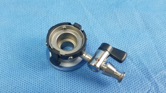 Silver and black metallic irrigation port with circular base handle compatible olympus endoscopic instrument component