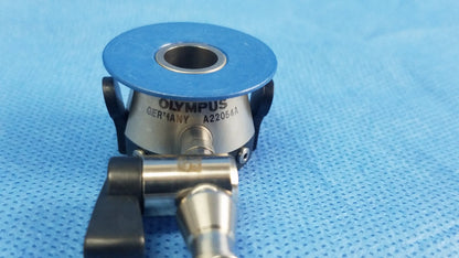 Olympus Germany A22054A irrigation port with a blue circular top and metallic body compatible with endoscopic instruments