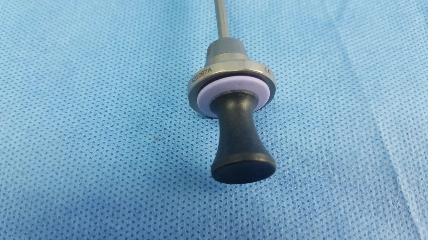 Black ergonomic handle with metallic collar and purple ring on a slender shaft of olympus germany a22087a obturator deflecting tip