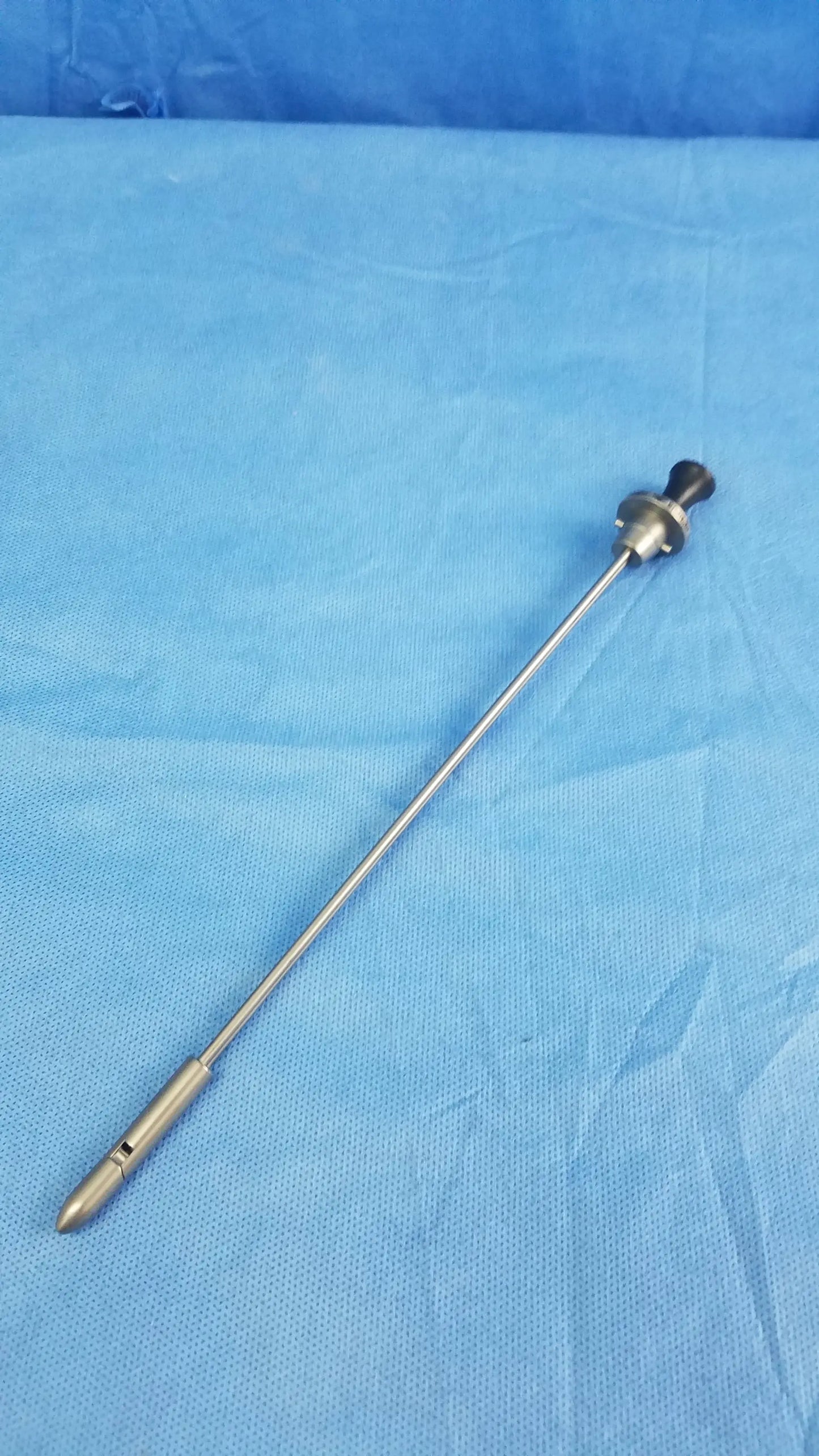 Silver surgical endoscope with black-tipped handle and metallic shaft featuring Olympus Germany A22087A obturator deflecting tip