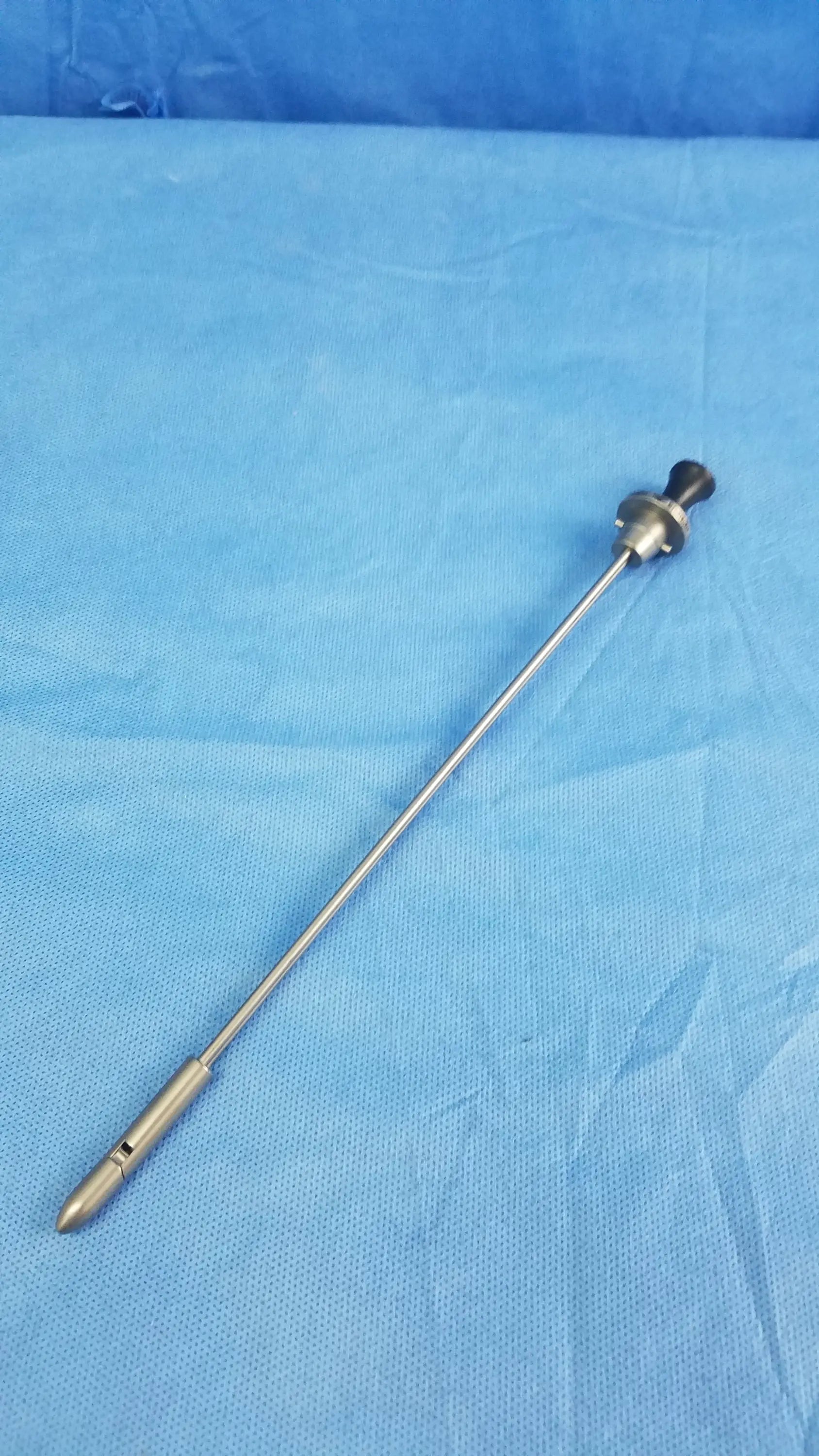 Silver surgical endoscope with black-tipped handle and metallic shaft featuring Olympus Germany A22087A obturator deflecting tip