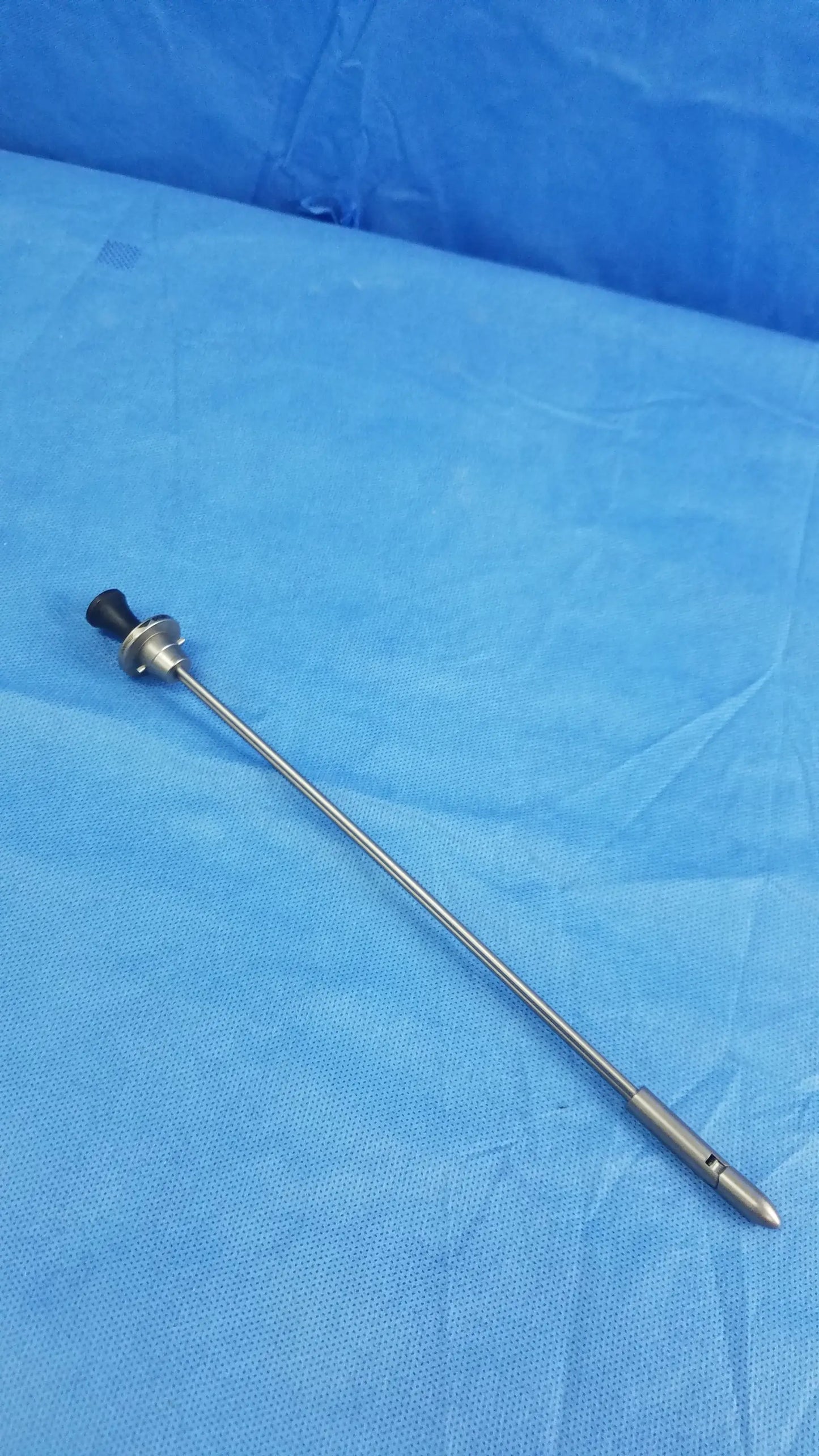 Silver surgical endoscope with black rubberized handle and metallic tip featuring olympus germany obturator deflecting tip