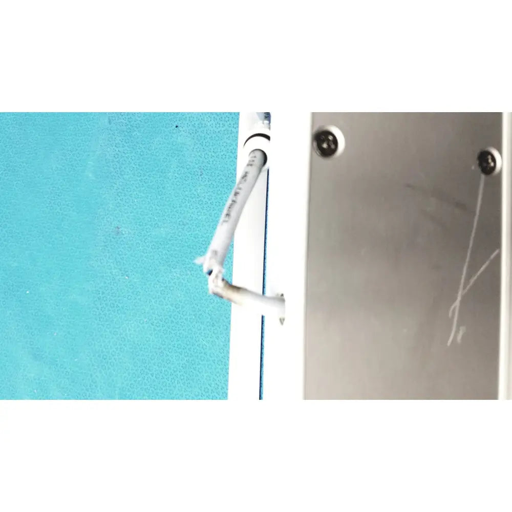 A white insulated electrical cable emerging from the back of an Olympus MAJ-1258 UES-40 pedal foot switch panel