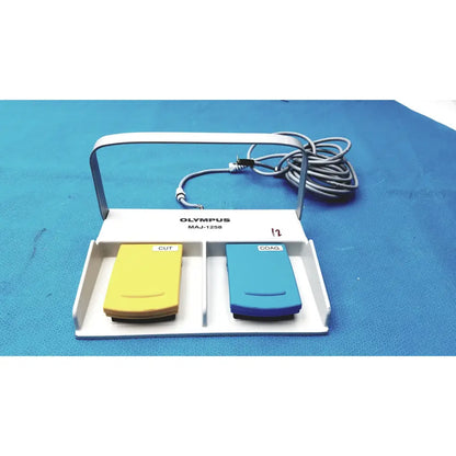 White Olympus MAJ-1258 UES-40 surgical pedal foot switch with yellow cut and blue coag buttons for precise control
