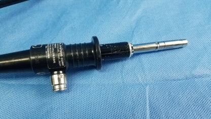 Black and silver flexible fiber optic endoscope with textured grip and metallic tip by Olympus Medical Systems