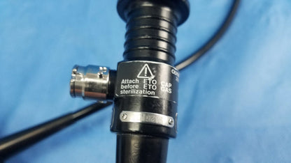 Black flexible fiber optic endoscope with metallic connector and warning label by olympus medical systems type ENF-P4