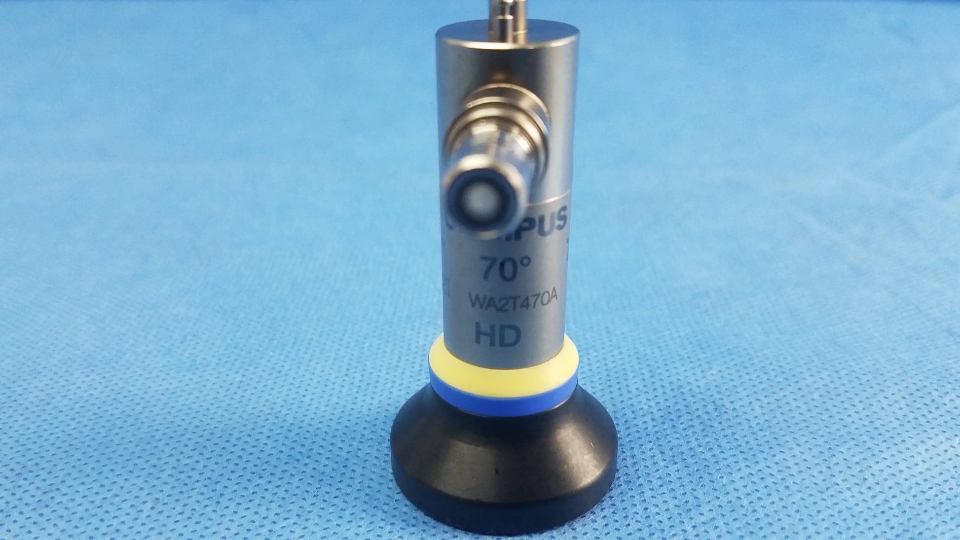 Silver cylindrical oes elite rigid telescope lens with black base yellow-blue ring marked 70° hd model wa2t470a