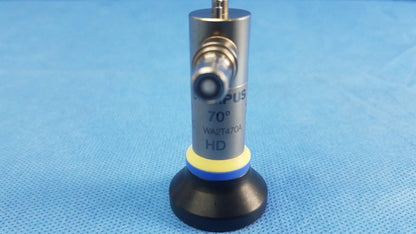 Silver cylindrical oes elite rigid telescope lens with black base yellow-blue ring marked 70° hd model wa2t470a