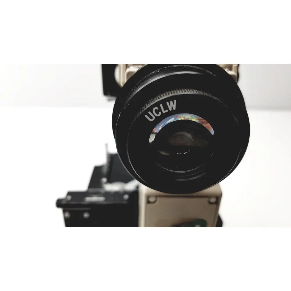 Black olympus optical bh2-uma microscope camera lens with uclw engraving and colorful iridescent reflection on the rim