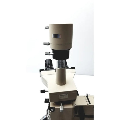 Beige Olympus Optical BH2-UMA microscope with black optics and metallic adjustment knobs for precise laboratory use