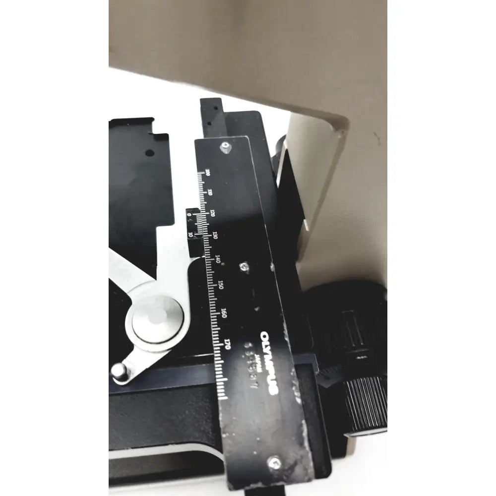 Black Olympus Optical BH2-UMA microscope ruler with white markings and silver screws for precision measurement