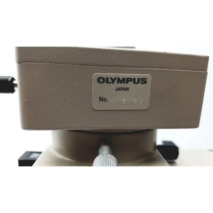 Beige olympus optical bh2-uma microscope base with a silver label showing brand name and serial number
