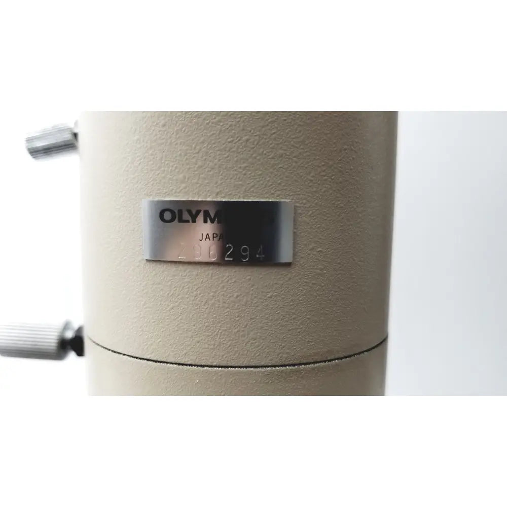 Beige olympus optical bh2-uma microscope body with silver nameplate displaying olympus japan and serial number