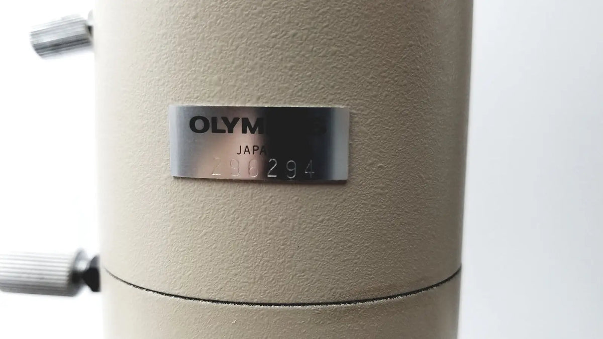 Beige olympus optical bh2-uma microscope body with silver nameplate displaying olympus japan and serial number