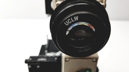 Black olympus optical bh2-uma microscope camera lens with uclw engraving and colorful iridescent reflection on the rim