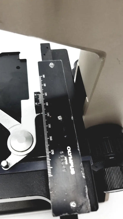 Black Olympus Optical BH2-UMA microscope ruler with white markings and silver screws for precision measurement