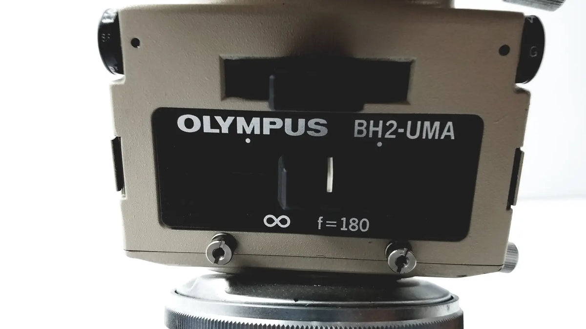 Olympus optical bh2-uma microscope with beige body and black label featuring white text for precise laboratory use