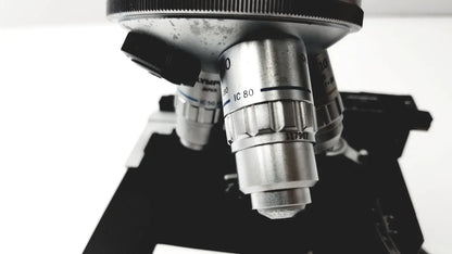 Silver metallic microscope objective lens with engraved markings and black adjustment knob for olympus optical bh2-uma microscope
