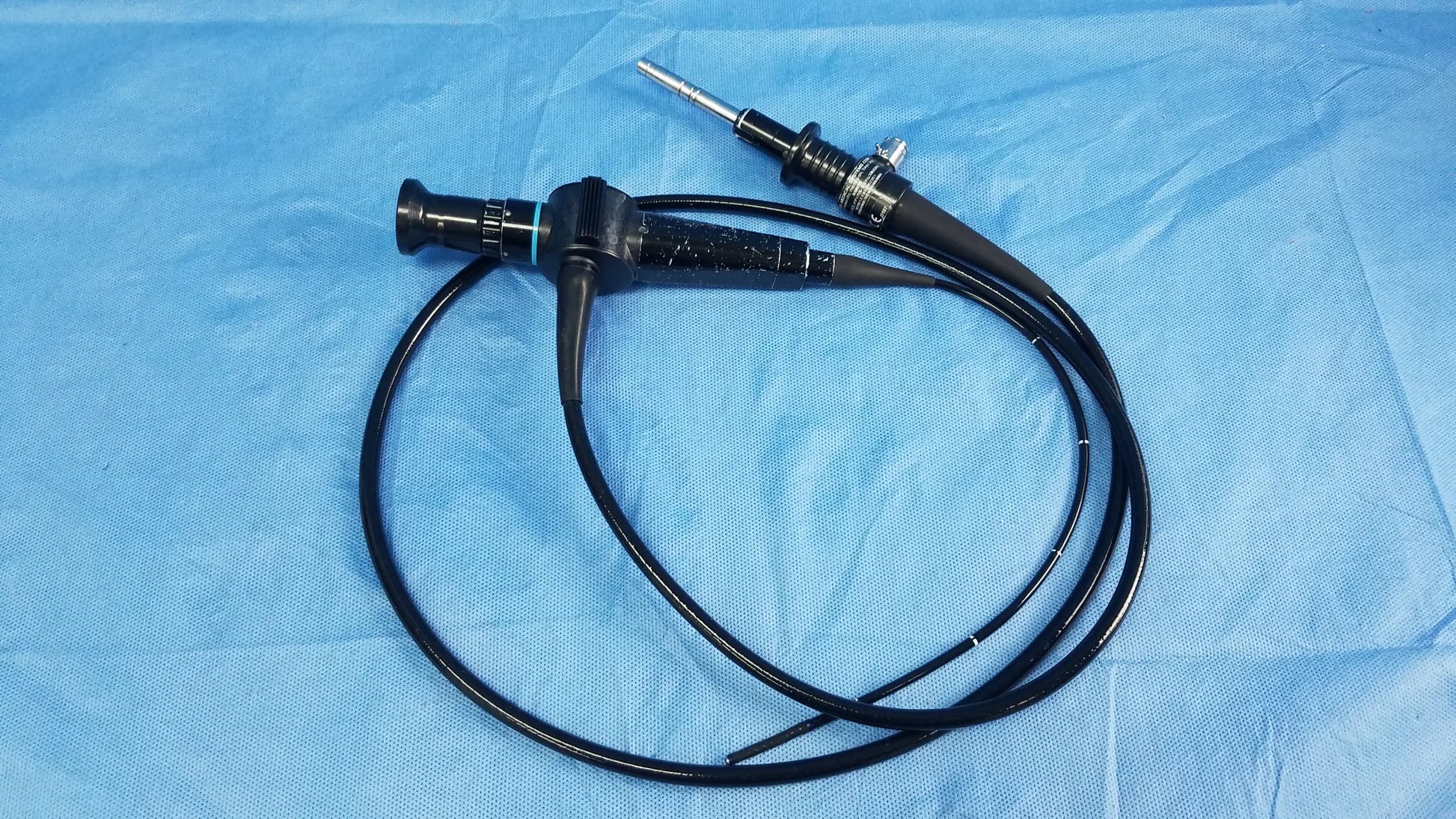 Black flexible fiber optic endoscope with metallic tip and control knobs for rhino-laryngoscope use by Olympus