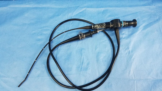 Black flexible fiber optic endoscope with metallic joint and control knobs coiled on blue surgical drape Olympus Rhino-Laryngoscope fiberscope