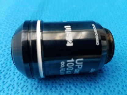Black microscope objective lens with white lettering and silver ring compatible olympus numerical aperture 1.40